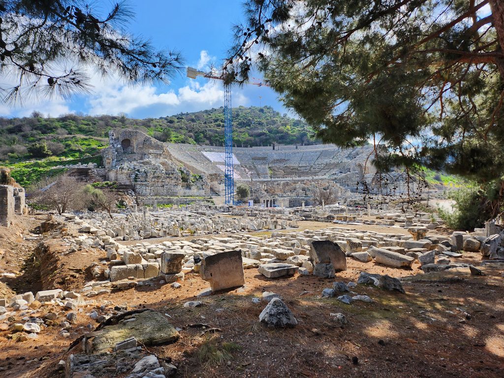 A panoramic view of the Great Theatre of Ephesus, showcasing its grand Hellenistic and Roman architecture amidst ongoing restoration.