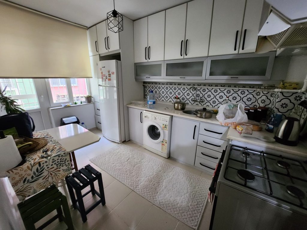 Kitchen & Dining Area. Well-equipped with essentials including a washing machine and a refrigerator