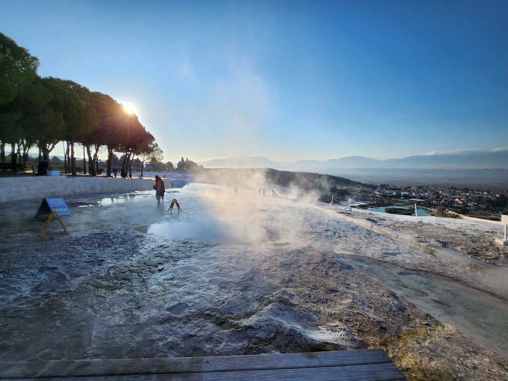 The official barefoot zone entry point where travelers must remove their shoes to touch the warm flowing thermal waters