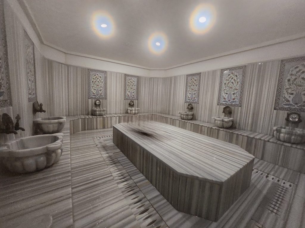 The central heart of the hammam: the massive, heated octagonal marble platform known as the 'Göbektaşı'