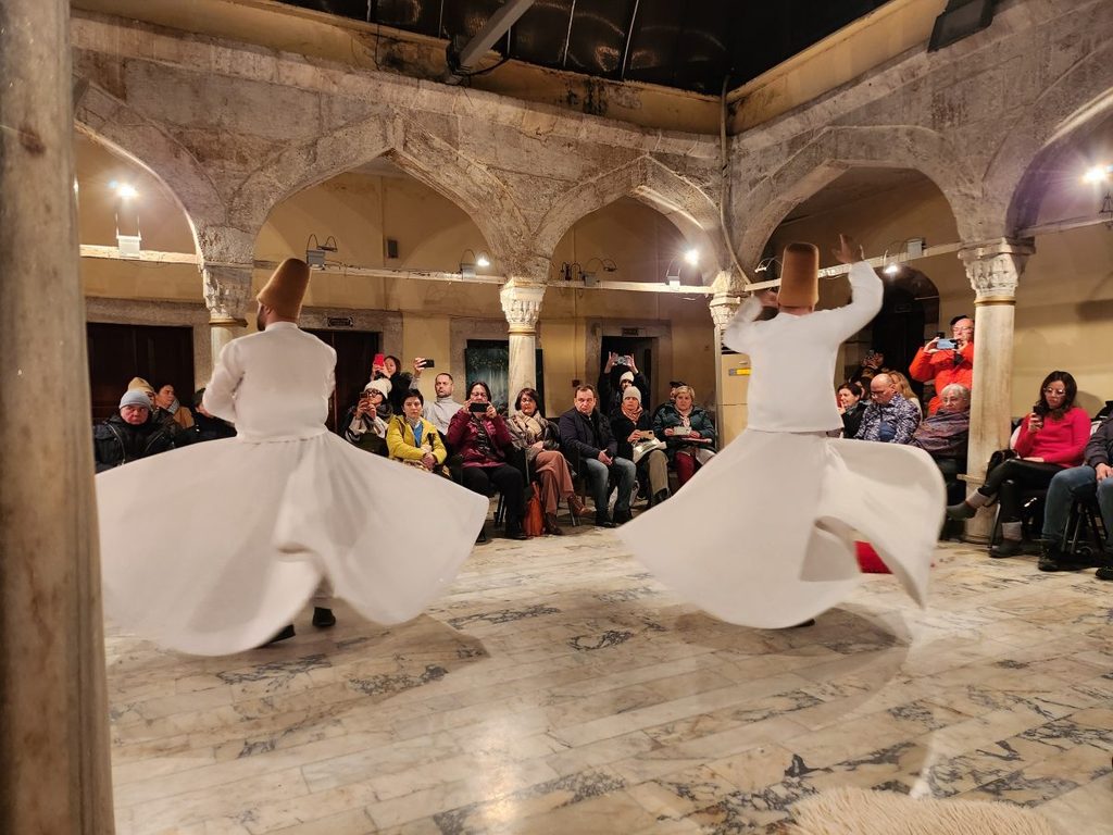 A scene of a mysterious Sufi Sema ritual being performed while wearing white robes.