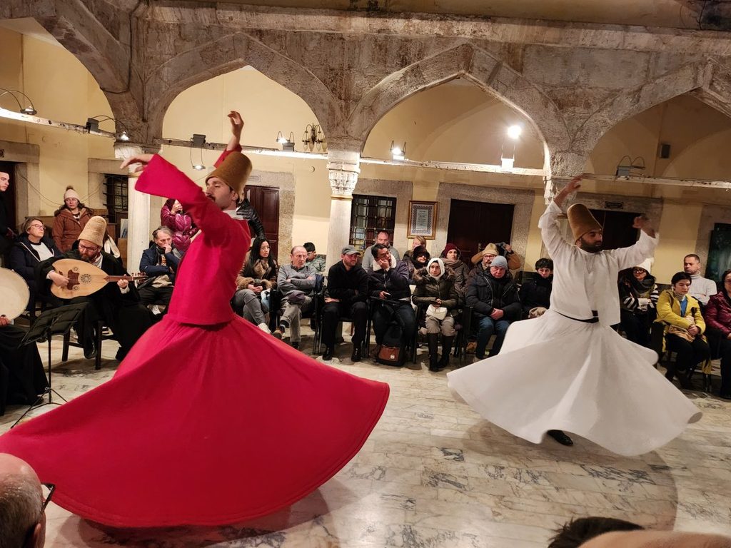 While modern creative performances sometimes feature red skirts for visual effect, the shroud (skirt) in the religious ceremonies of the orthodox Mevlevi order, which has been practiced for centuries, is strictly white.