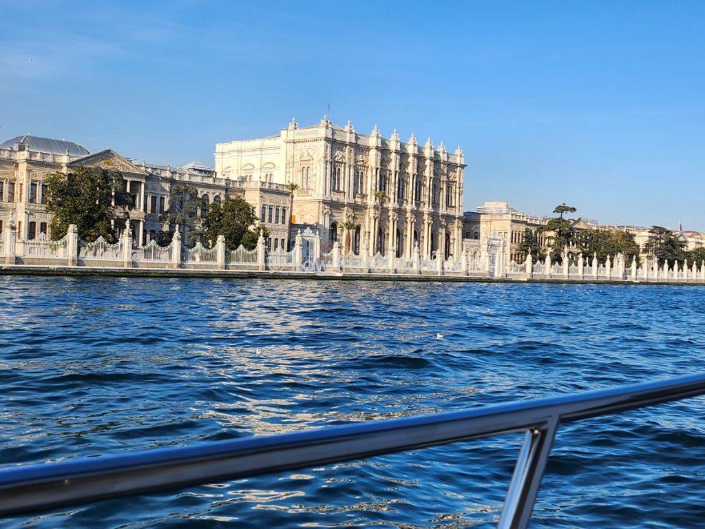 The Bosphorus Bridge reveals its majestic presence in the distance (left), while the Dolmabahçe Palace—visited earlier in the day—offers a completely different perspective when viewed from the water (right).